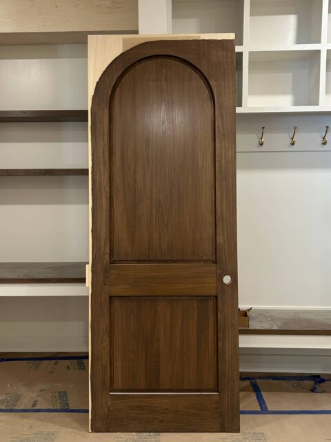 Pull up a chair. Today we're talking pocket doors, and a mistake we see more often than we'd like.

𝗧𝗮𝗸𝗲 𝗮 𝗴𝗼𝗼𝗱 𝗹𝗼𝗼𝗸 𝗮𝘁 𝘁𝗵𝗶𝘀 𝗽𝗵𝗼𝘁𝗼.

See that light-colored strip running across the top and down the side of the door? That's raw wood. No stain. No sealer. No finish.

Once that unfinished door disappears into the wall, you've placed raw wood into a cavity surrounded by construction materials that are still releasing moisture.

Framing lumber can contain significantly more moisture than the door. Drywall joint compound releases moisture into the surrounding air as it dries.

And unfinished wood? It's essentially a sponge.

Wood naturally gains and loses moisture as the environment around it changes. When one portion of a door is sealed and another is left exposed, you're giving moisture an open invitation into the wood, creating an imbalance in how that door responds.

And what happens when that door starts absorbing moisture? It can swell, bow, or warp. Suddenly, that beautiful pocket door doesn't slide quite so smoothly. And fixing a door that's tucked inside a wall? Not exactly anyone's idea of a good time.

𝗧𝗵𝗲 𝗿𝘂𝗹𝗲 𝗶𝘀 𝘀𝗶𝗺𝗽𝗹𝗲: 𝗙𝗶𝗻𝗶𝘀𝗵 𝗮𝗹𝗹 𝘀𝗶𝘅 𝘀𝗶𝗱𝗲𝘀. 𝗧𝗵𝗲𝗻 𝗶𝗻𝘀𝘁𝗮𝗹𝗹 𝘁𝗵𝗲 𝗱𝗼𝗼𝗿. 😏