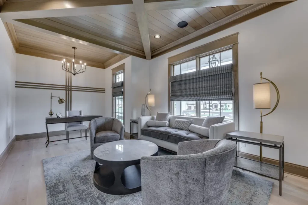 Home office with sofa and chairs and wood moulding ceiling