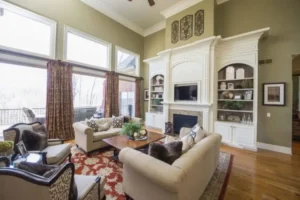 Living room with building in wall system surrounding fireplace