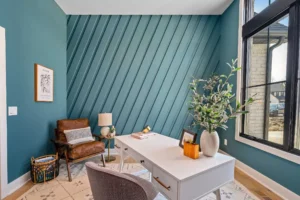 Teal colored wall with diagonal wall moulding