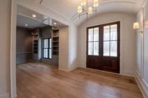 Empty foyer with wood flooring, wood doors and case openings